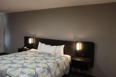 a bedroom with a bed with two night stands and two lamps at Motel 6-San Diego, CA - Southbay in Chula Vista