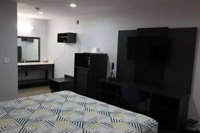 a hotel room with a bed and a television at Motel 6-San Diego, CA - Southbay in Chula Vista