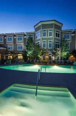 a swimming pool in front of a building at West Inn & Suites in Carlsbad