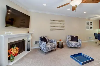 a living room with two chairs and a fireplace at North Coast Village Retreat B111 in Oceanside