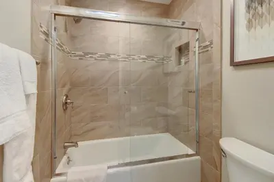 a shower with a glass door in a bathroom at North Coast Village Retreat B111 in Oceanside