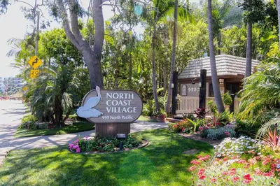 a sign for a notitz cost village in a park at North Coast Village Retreat B111 in Oceanside