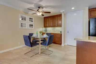 a kitchen with a table with chairs and a ceiling fan at North Coast Village Retreat B111 in Oceanside