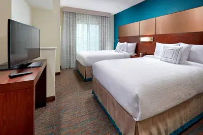 a hotel room with two beds and a flat screen tv at Residence Inn by Marriott San Diego Chula Vista in Chula Vista