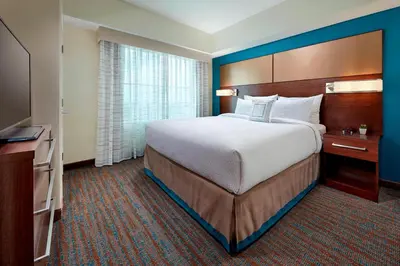 a hotel room with a large bed and a television at Residence Inn by Marriott San Diego Chula Vista in Chula Vista