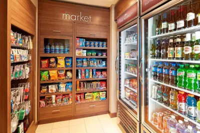 a store aisle with a refrigerator and lots of food at Residence Inn by Marriott San Diego Chula Vista in Chula Vista