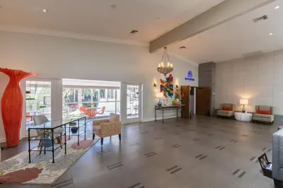 a lobby with a table and chairs and a dining room at San Clemente Inn in San Clemente