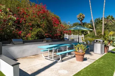 a patio with a table and an umbrella at San Clemente Inn in San Clemente