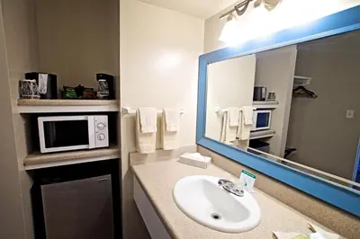 a bathroom with a sink and a microwave at Ocean Villa Inn in San Diego