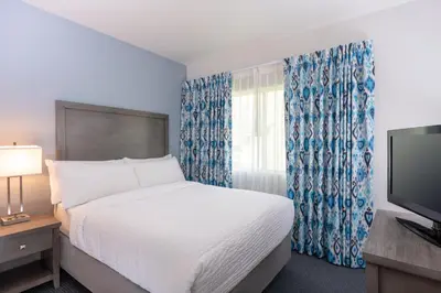 a hotel room with a bed and a television at Beachfront Inn and Suites at Dana Point in Capistrano Beach