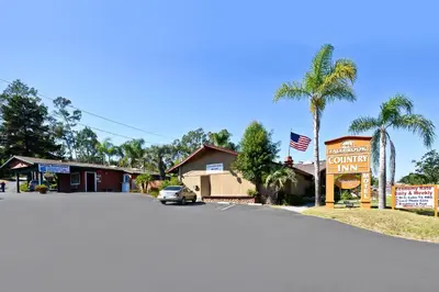 a street in a small town with a car on the road at Fallbrook Country Inn in Fallbrook