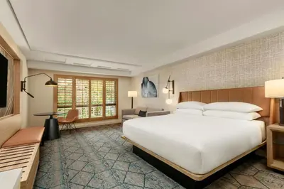 a bedroom with a large white bed and a couch at Sheraton La Jolla in San Diego