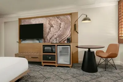 a living room with a tv and a table at Sheraton La Jolla in San Diego