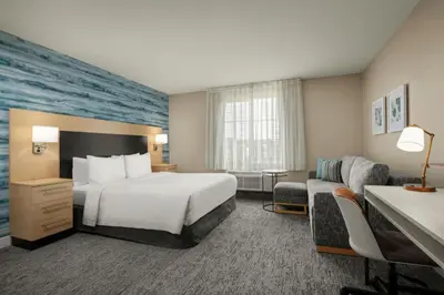 a hotel room with a bed and a couch at TownePlace Suites by Marriott San Diego Carlsbad / Vista in Vista