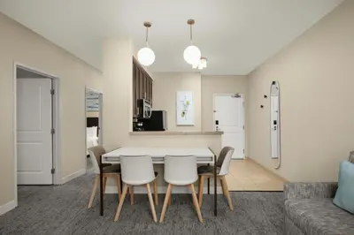 a kitchen and dining room with a table and chairs at TownePlace Suites by Marriott San Diego Carlsbad / Vista in Vista