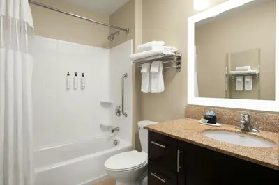 a bathroom with a sink and a toilet and a mirror at TownePlace Suites by Marriott San Diego Carlsbad / Vista in Vista