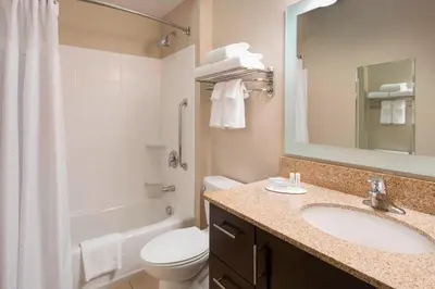 a bathroom with a sink and a toilet and a mirror at TownePlace Suites by Marriott San Diego Carlsbad / Vista in Vista