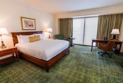a hotel room with a large bed and a desk at The Westgate Hotel in San Diego