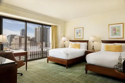 a hotel room with two beds and a large window at The Westgate Hotel in San Diego