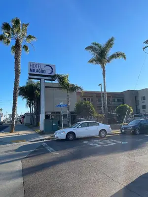 a white car parked in front of a hotel malibu at Hotel Milagro in Chula Vista