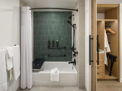 a bathroom with a white tub and a green wall at Guesthouse Hotel at La Valle in Rancho Santa Fe