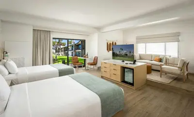 a hotel room with two beds and a living room at Guesthouse Hotel at La Valle in Rancho Santa Fe