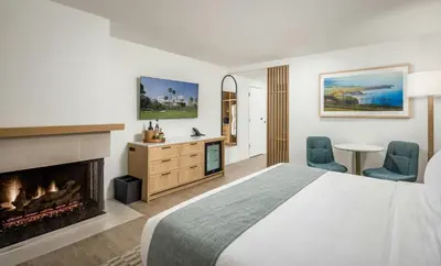 a hotel room with a bed and a fireplace at Guesthouse Hotel at La Valle in Rancho Santa Fe