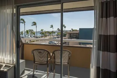 a balcony with two chairs and a view of the ocean at Bay Club Hotel and Marina in San Diego