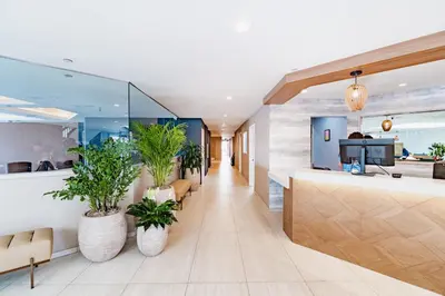 an office lobby with potted plants and a counter at Bay Club Hotel and Marina in San Diego