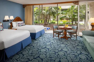 a hotel room with two beds and a patio at Catamaran Resort Hotel and Spa in San Diego