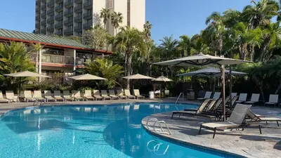 a large swimming pool with chairs and umbrellas at Catamaran Resort Hotel and Spa in San Diego