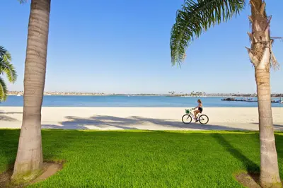 a woman riding a bike on the beach at Catamaran Resort Hotel and Spa in San Diego