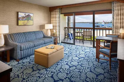 a living room with a couch and a table and a desk at Catamaran Resort Hotel and Spa in San Diego