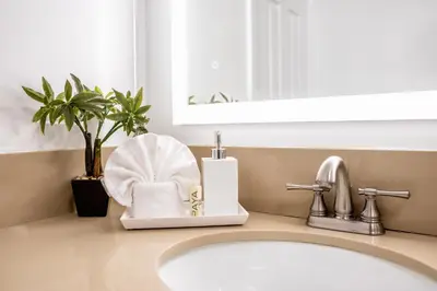 a bathroom counter with a sink and a mirror at Little Inn By The Bay Newport Beach Hotel in Newport Beach