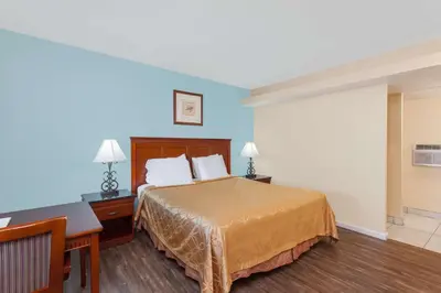 a hotel room with a bed and a desk at Travelodge by Wyndham San Diego SeaWorld in San Diego