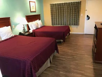 a hotel room with two beds and a television at Travelodge by Wyndham San Diego SeaWorld in San Diego