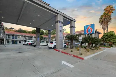 a parking lot with cars parked in front of a hotel at Motel 6-La Mesa, CA in San Diego