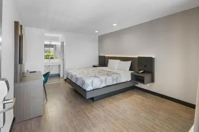 a bedroom with a bed and a desk in it at Motel 6-La Mesa, CA in San Diego