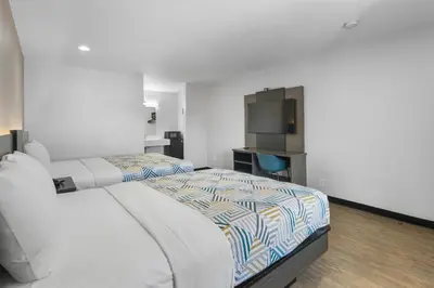 a bedroom with a large bed and a television at Motel 6-La Mesa, CA in San Diego