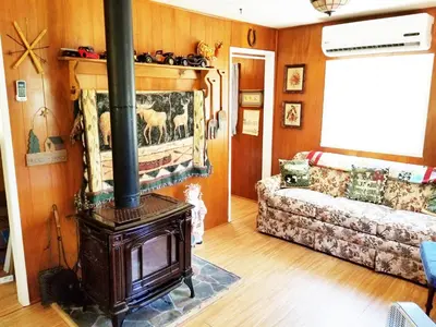 a living room with a wood stove and a couch at Time Traveler Retreat in Julian