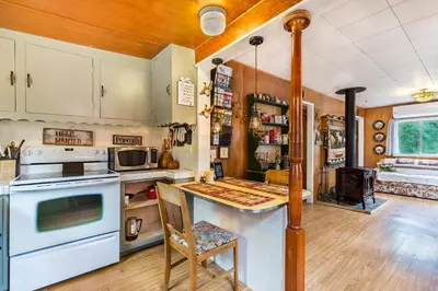 a kitchen with white appliances and a table in a room at Time Traveler Retreat in Julian
