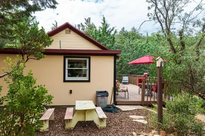 a small house with a picnic table and a patio at Time Traveler Retreat in Julian