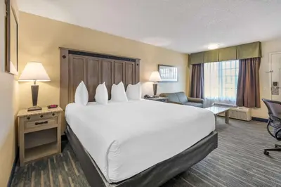a large white bed in a hotel room at Best Western Americana Inn in San Ysidro, San Diego