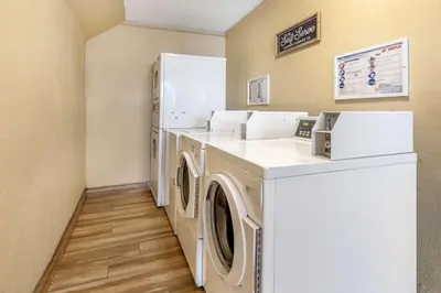 a laundry room with a washer and dryer and a refrigerator at Best Western Americana Inn in San Ysidro, San Diego