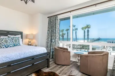 a bedroom with a bed and a view of the ocean at Ocean View 3 Bedrooms Condo, just steps from the park, pier & water! in Imperial Beach