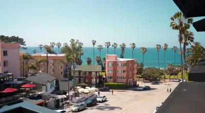 a view of a city with palm trees and the ocean at Cormorant Boutique Hotel in San Diego