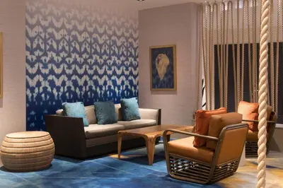 a living room with a couch and a chair at Renaissance Newport Beach Hotel in Newport Beach