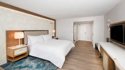 a bedroom with a bed and a flat screen tv at Renaissance Newport Beach Hotel in Newport Beach