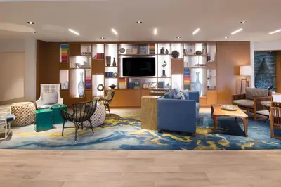 a living room filled with furniture and a flat screen tv at Renaissance Newport Beach Hotel in Newport Beach