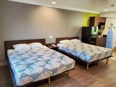 a hotel room with two beds and a kitchen at Studio 6-National City, CA - Naval Base San Diego in National City